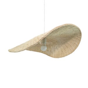 Large wavy rattan pendant lamp hanging over dining table in modern hotel resort